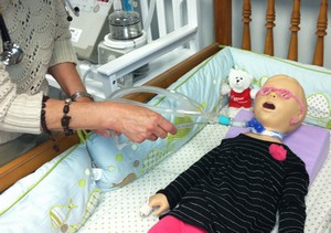 As a training exercise, a nurse practices suctioning technique on a pediatric simulation mannequin that is connected to a home care ventilator at the BAYADA Home Health Care Simulation Lab. nurse practices suctioning technique on a pediatric simulation mannequin